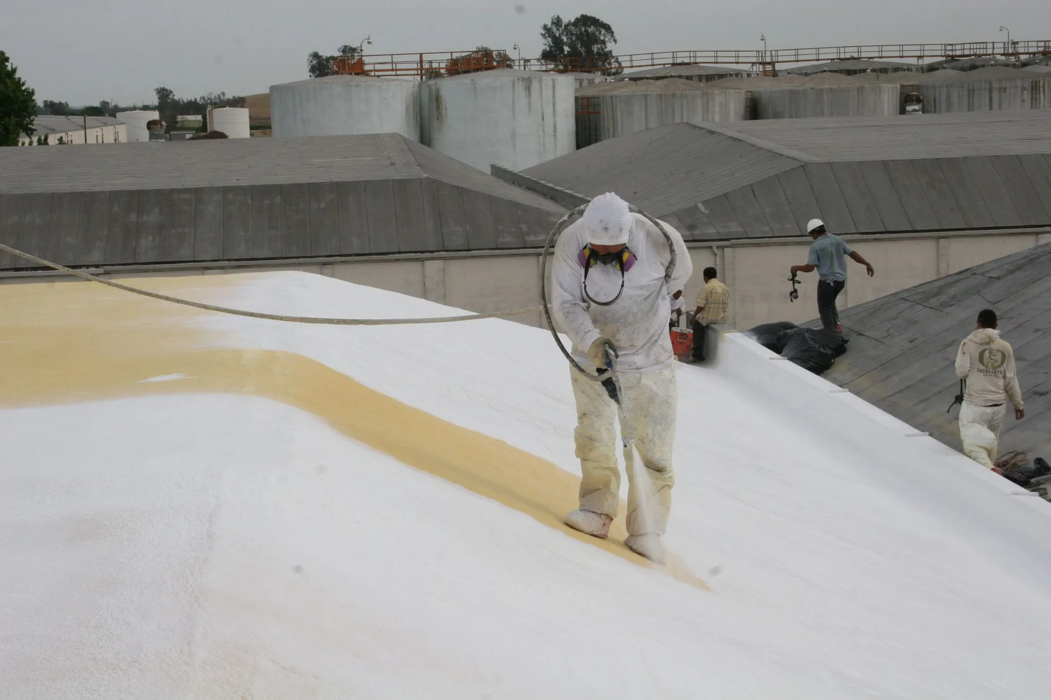 Hulsey Contracting crew applying spray foam roofing